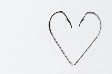A heart of Fishing hooks isolated on white background. Love fishing concept .