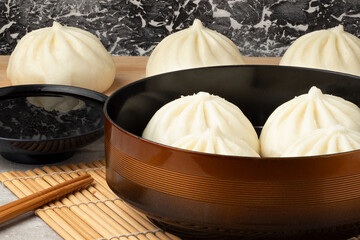 Delicious asian nikuman served with soy sauce.