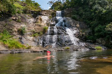 Diyaluma Falls, Sri Lanka A man bathing in the waterfall pool.