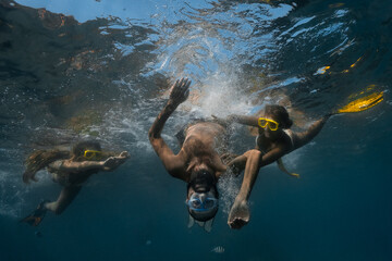 Fototapeta na wymiar Young friends snorkeling and having fun in a tropical sea.