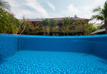 Split photography of swimming pool, tropical trees with villa and blue skies.
