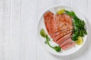 fried tuna steak with boiled broccolini and lime