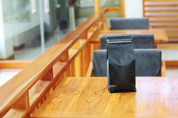 Photo of coffee packaging standing pouch size 1 Kg on the cafe table. suitable for mock up label...