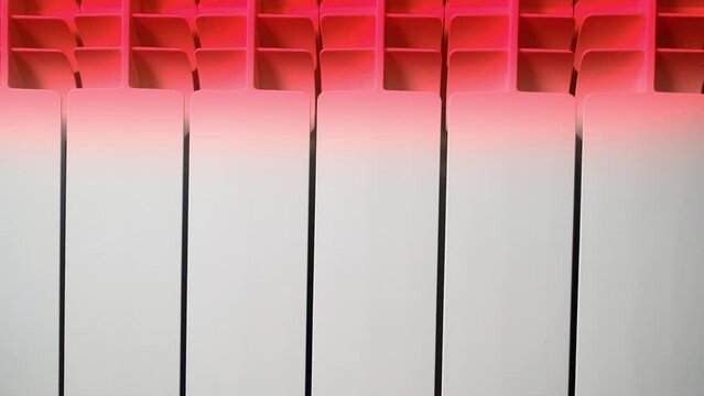 Bimetallic heating radiator heated to red. Heat dissipation of a water radiator in a room
