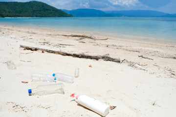Water bottles, plastic bottles and lots of dirt on the beach. that a lot of people have abandoned global warming concept
