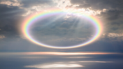 Aerial view of calm sea before storm with amazing rounded rainbow at sunset   