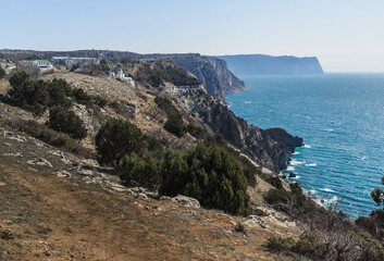 Fototapeta na wymiar View of Crimean rugged rocky shore with Saint George Monastery in spring. Sevastopol, Crimea