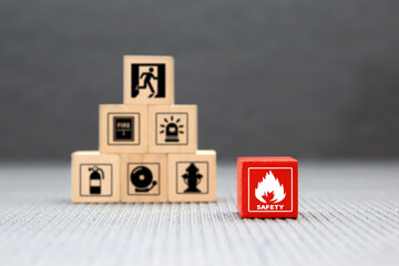 Cube wooden block stack with fire icon and door exit sing or fire escape with prevent icon and fire...