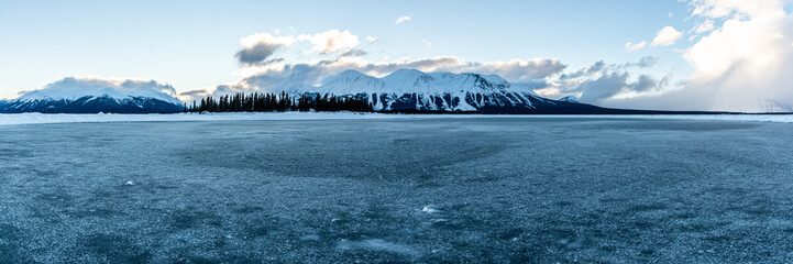 Panoramic view of a winter scene in northern Canada during January with snow capped mountains. 