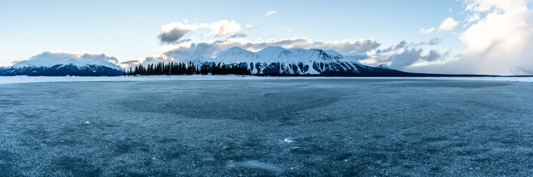 Panoramic view of a winter scene in northern Canada during January with snow capped mountains. 