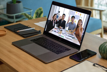 close up screen groupd of asian colleage video confernece business plan with laptop on table at home
