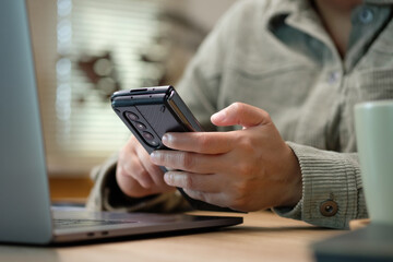 asisn woman use mobile while video conference meeting online with laptop at home
