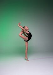 girl shows elements from rhythmic gymnastics