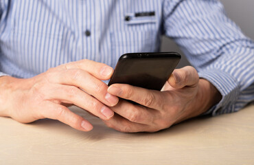 Man hands closeup with phone. Using smartphone for work, social communication, education,online shopping, information search, relax. High quality photo