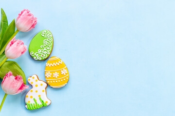 Happy Easter with pink tulips and cookies. Easter background