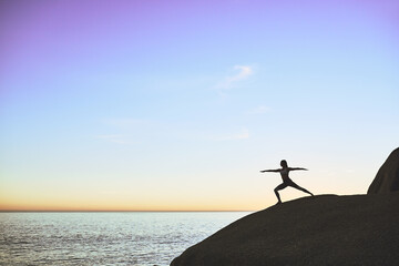 Yoga benefits the mind and body. Shot of an athletic young woman practicing yoga on the beach.