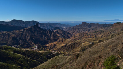 Stunning panoramic view of the central mountains of Gran Canaria, Spain viewed from Cruz de Tejeda with famous rock Roque Bentayga and island Tenerife.