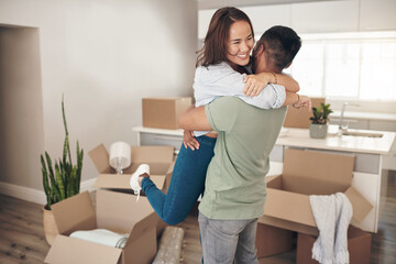 Owning your own house is the best feeling ever. Shot of a couple looking cheerful while moving into...