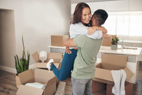 Owning Your Own House Is The Best Feeling Ever. Shot Of A Couple Looking Cheerful While Moving Into Their New Home.