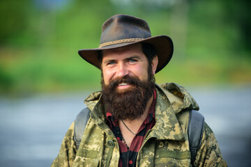 Portrait of happy man traveler with backpack hiking outdoor. Travel lifestyle countryside and...