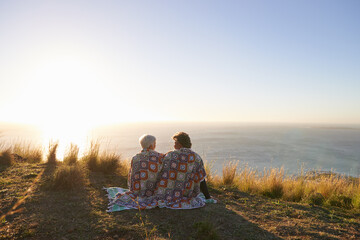 Sharing a sweet moment. View of a senior couple sitting on a hillside together.