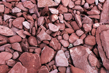 the texture of the stones. red pebbles on the beach.