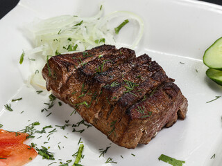 Grilled beef steak served onion