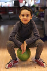 Fototapeta premium a boy is playing bowling.