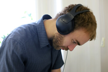 portrait of a man. he is an engineer and a musician. the guy with the headphones.