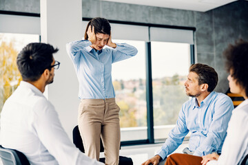 Support group helping a woman with burnout.