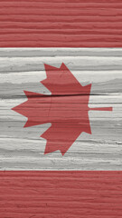 Fragment of Canadian flag on a dry wooden surface. Natural vertical background. Mobile phone...