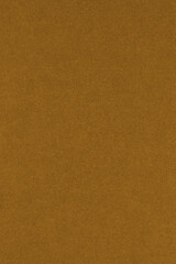 Brown colored paper texture. Сoloured vertical background or wallpaper. Textured surface with cellulose fibers