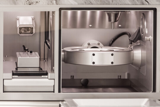 Cad cam milling machine in dental laboratory. Production of high esthetic dental crowns and dentures.