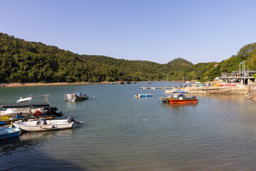 Fototapeta na wymiar various Junks park at harbor or small port in villages in Sai Kung, Hong Kong