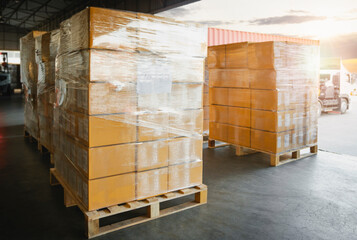 Packaging Boxes Stacked Wrapped Plastic on Pallets Loading with Shipping Cargo Container. Delivery Trucks Loading at Dock Warehouse. Supply Chain. Shipment Logistics. Distribution Freight Transport.