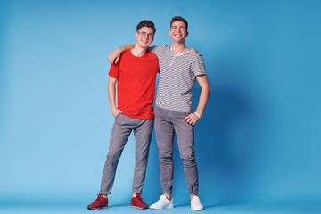 Colorful studio portrait of two happy smiling friends.