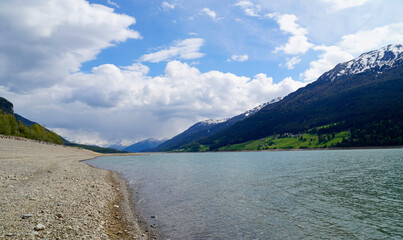 a picturesque view of lake Resia near the sunken church steeple of Lago di Resia in the Curon region (Vinschgau or Curon, South Tyrol, Italy)	