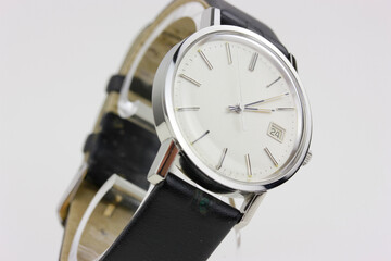 puristic antique silver watch swiss made used worn wristwatch isolated elegant noble retro classic luxurious front view close up Macro rare pocketwatch with black leather bracelet band strap modern