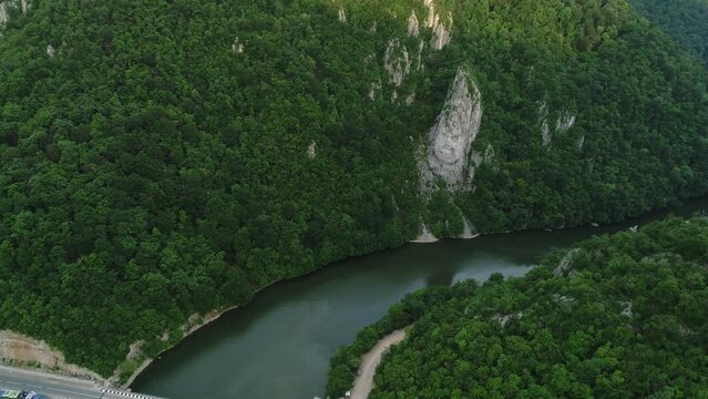 4K aerial view of Decebal Head sculpted in rock landmark from Danube Gorges in Romania, early in the morning.