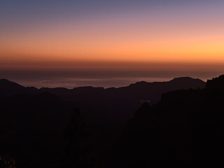 Beautiful view over the southern mountains of island Gran Canaria, Canary Islands, Spain after sunset with colorful sky above the Atlantic Ocean.