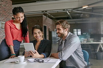 Were making great headway on the project. Shot of a group of colleagues having a brainstorming session in a modern office.
