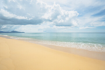 Panorama white sand popular beach waves texture lapping across untouched shore.