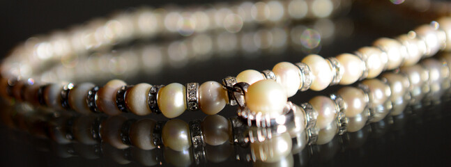 pearl necklace with silver on a black background. High quality photo
