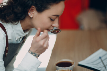 Cup Taster Woman with Spoon in Hands Tasting Degustation Coffee Quality Test. Coffee Cupping Concept