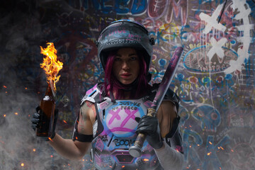 Tattooed woman activist with molotov holding baseball bat