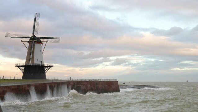 Windmill by sea during storm called Corrie, Vlissingen, Netherlands