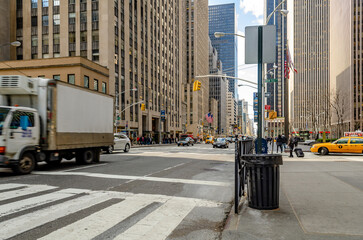 Manhattan New York City, Street near Radio City Music Hall with lots of traffic, crosswalk and trash bin in the forefront, horizontal