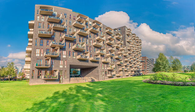 modern futuristic residential house with rectangular balconies near a green Byparken park in &Oslash;restad city area. Copenhagen, Denmark