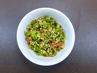 Top view of Pound green mixed red chilies isolated on white bowl as a background, Ready to cooking