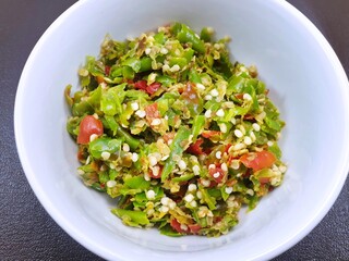 Top view of Pound green mixed red chilies isolated on white bowl as a background, Ready to cooking